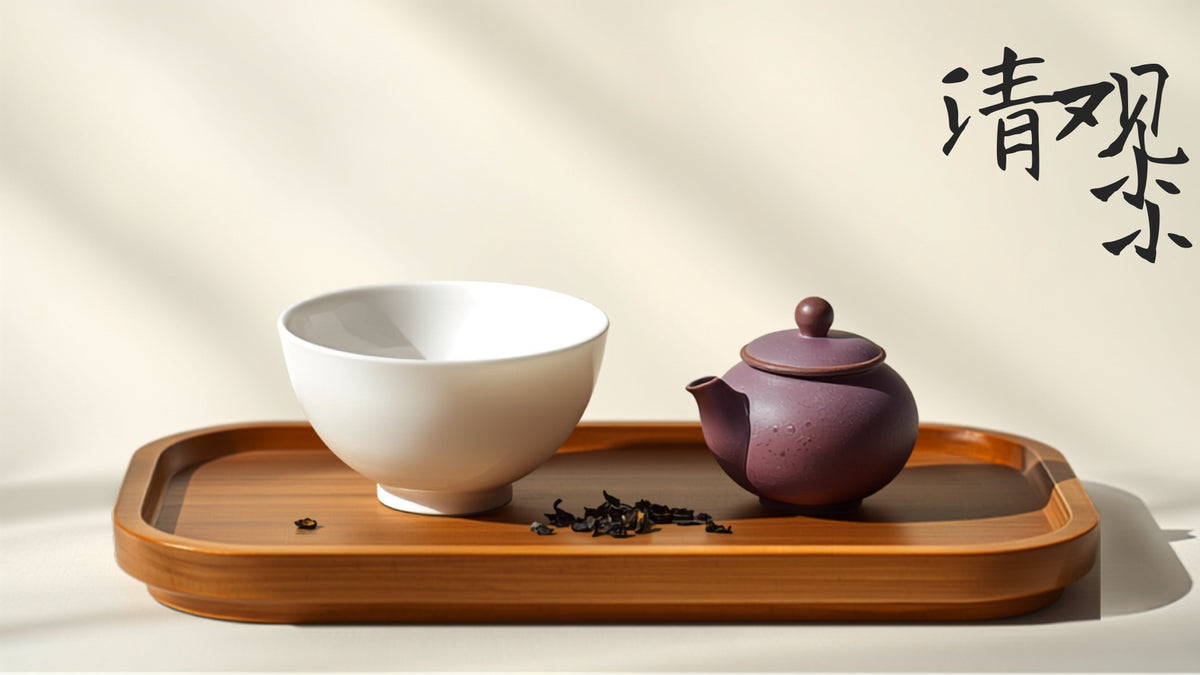 A porcelain gaiwan beside a purple clay Yixing teapot